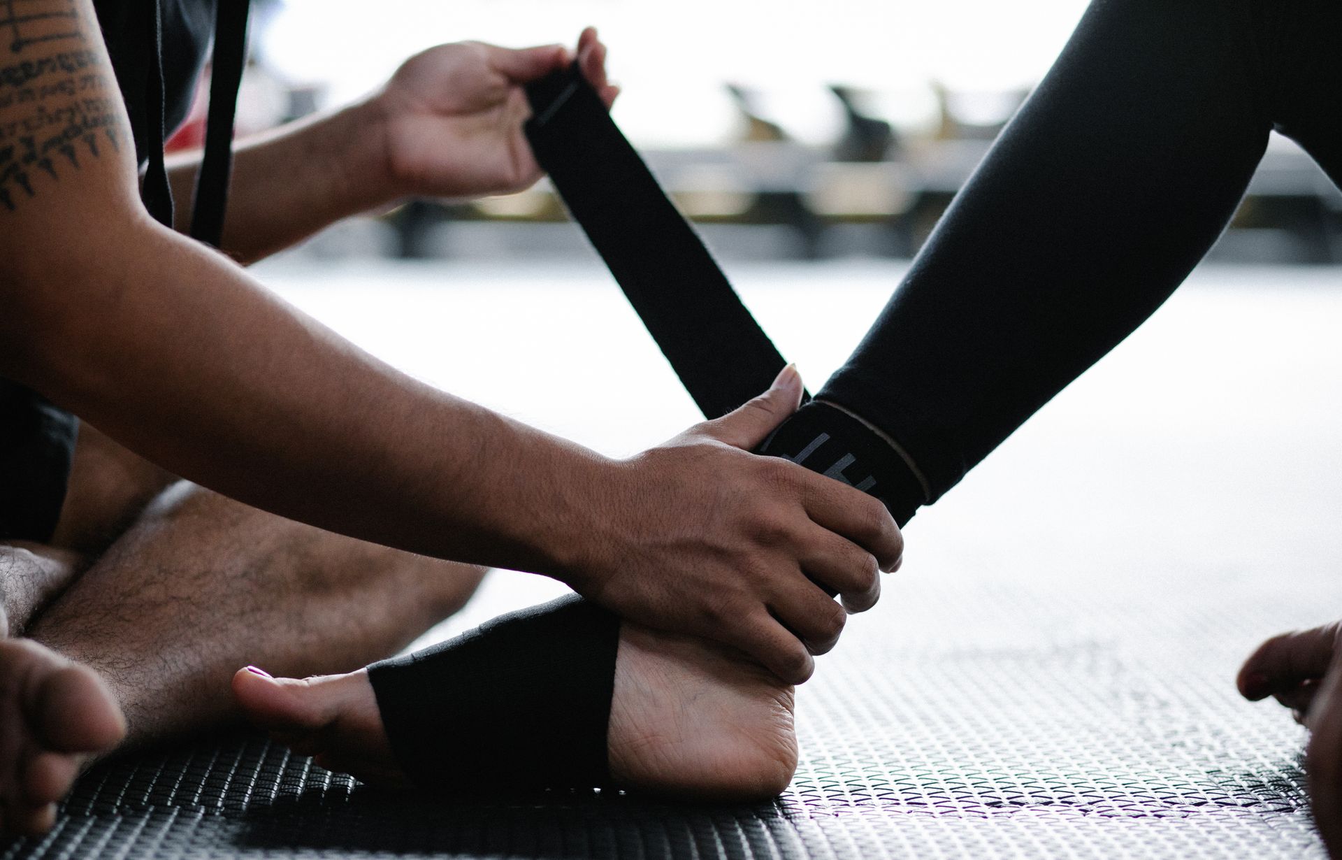 An athlete's ankle being wrapped with elastic tape